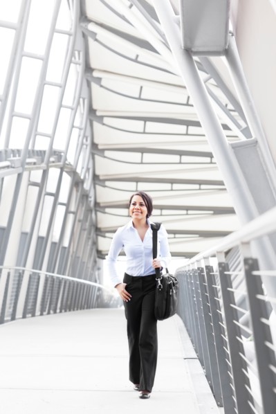 Young businesswoman on walkway. Photo: Take A Pix Media