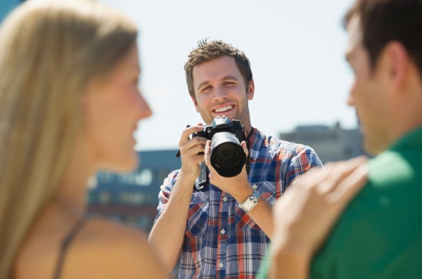 Photographer taking picture of couple.