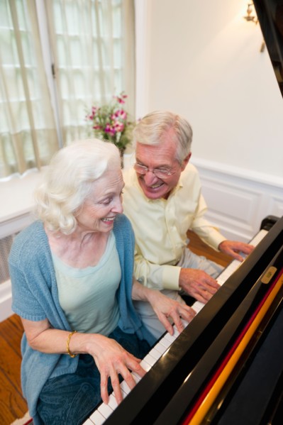 Senior couple playing piano.