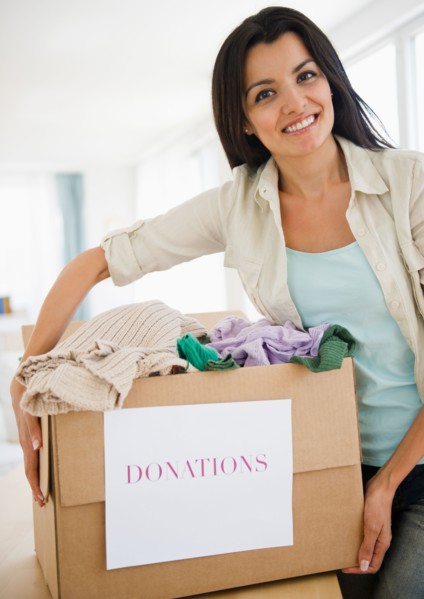 Woman preparing clothes for charity. Photo : Jamie Grill