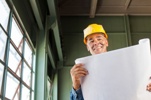 Portrait of architect holding blueprint. Photo : db2stock