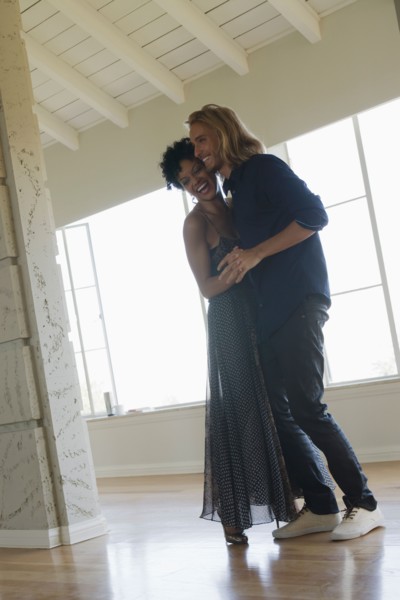 Young couple dancing in empty room. Photo : Rob Lewine