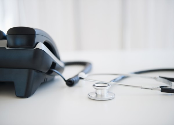 Close up of phone and stethoscope on doctor's desk. Photo : Jamie Grill