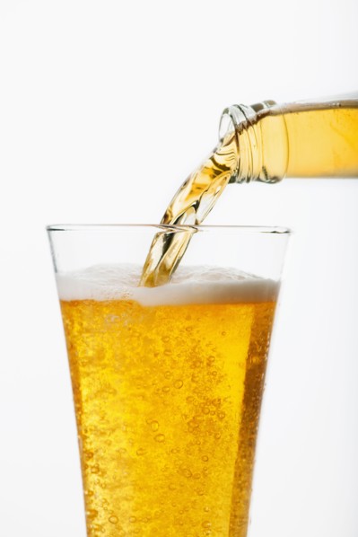 Beer pouring into glass, studio shot.