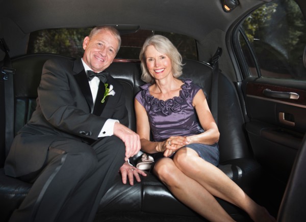 Portrait of parents of bride in limousine.