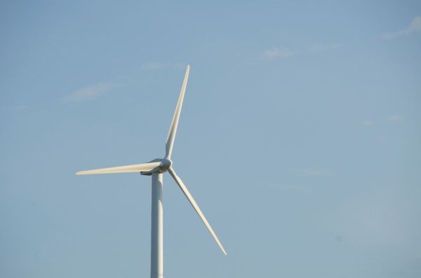 Turkey, Izmir, wind turbine against blue sky. Photo: Tetra Images