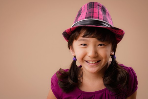 Studio portrait of girl (10-11) wearing hat. Photo : Rob Lewine