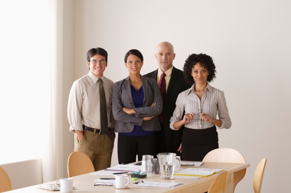 Portrait of business team in board room. Photo : Rob Lewine