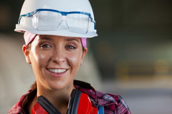 Portrait of female manual worker wearing hardhat. Photo : db2stock