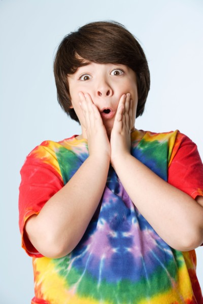 Studio portrait of boy (10-11) in colorful shirt. Photo : Rob Lewine