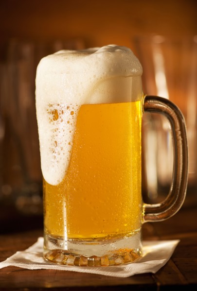 Lager in beer glass on bar counter.