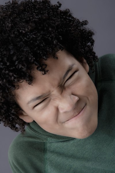 Portrait of boy (8-9) looking angry, studio shot. Photo: Rob Lewine