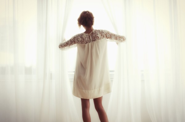 Woman looking out window.