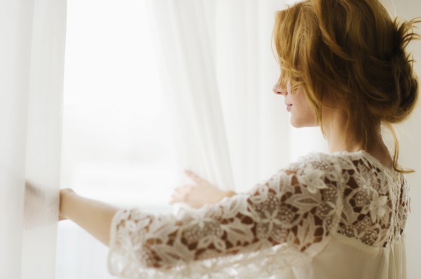 Woman looking out window.