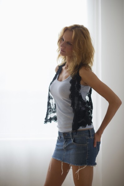 Woman standing by window.