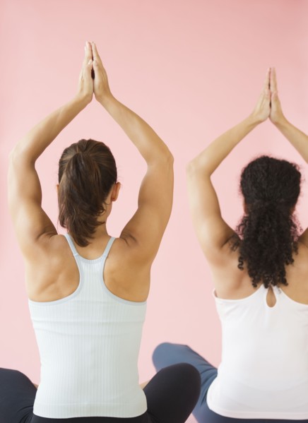 Two women exercising, studio shot.