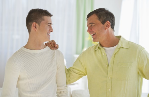 Father and son (16-17) talking.