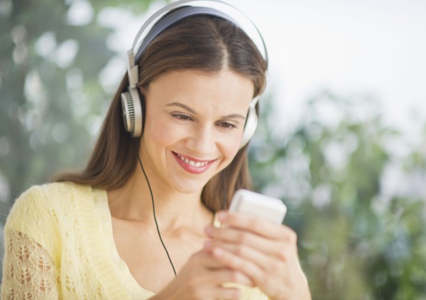 Woman with headphones outdoors.