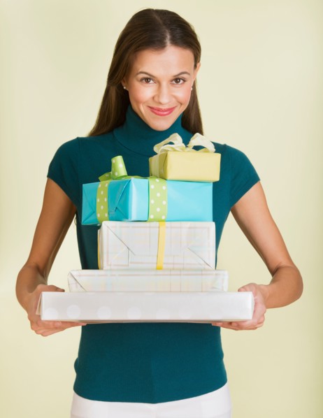 Studio shot of woman holding presents.