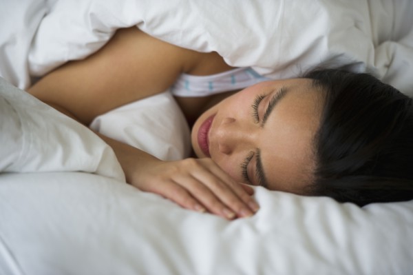 Woman sleeping in bed.