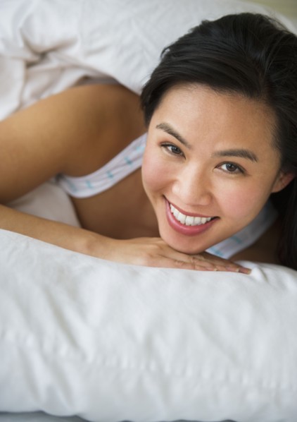Woman lying in bed.