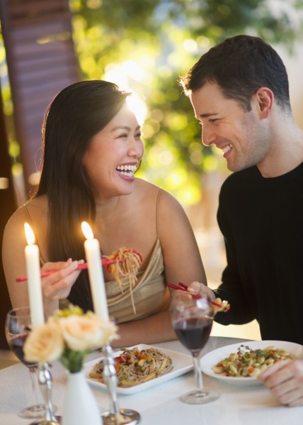 Couple enjoying fine meal in restaurant.