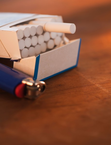 Close up of open cigarette pack and lighter. Photo: Daniel Grill