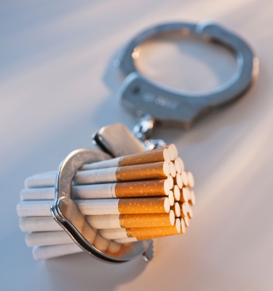 Close up of bunch of cigarettes locked in handcuffs. Photo: Daniel Grill