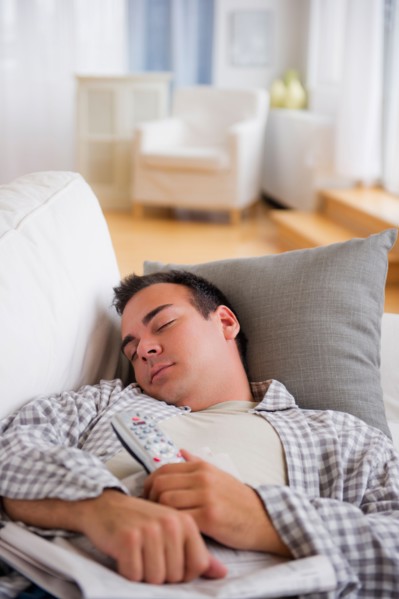 Man resting on sofa. Photo : Daniel Grill
