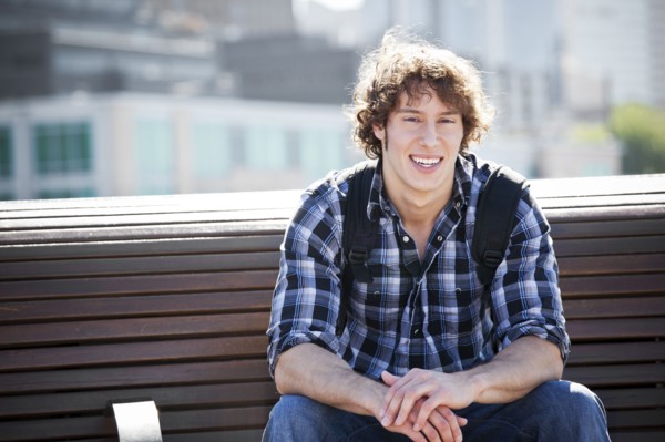 USA, Washington, Seattle, Young man sitting on bench. Photo : Take A Pix Media