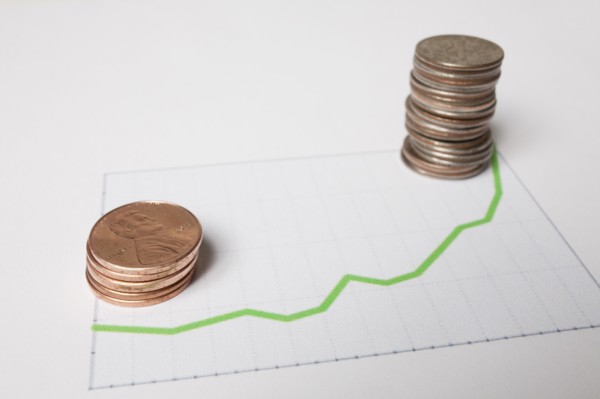 Coins on sheet of paper with graph. Photo : Winslow Productions
