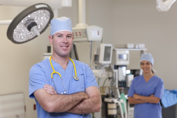 Portrait of male and female surgeons in operating room. Photo : db2stock