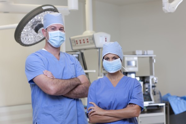Portrait of male and female surgeons in operating room. Photo : db2stock