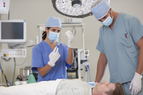 Surgeons preparing patient for surgery. Photo: db2stock