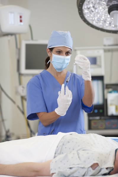 Surgeon preparing patient for surgery. Photo : db2stock