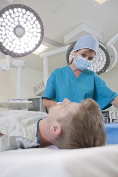Surgeon preparing patient for surgery. Photo: db2stock