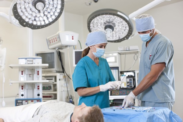 Surgeons preparing patient for surgery. Photo : db2stock