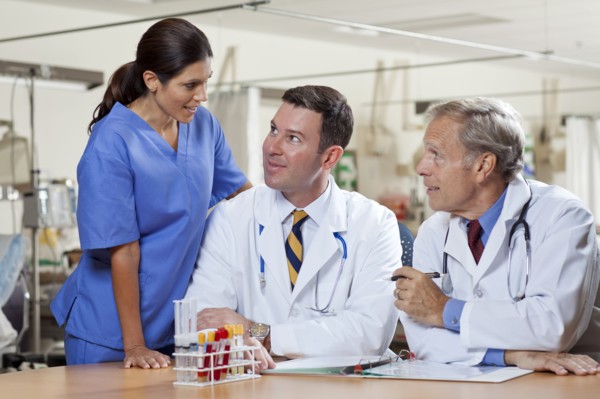 Female surgeon and two male doctors in hospital. Photo : db2stock