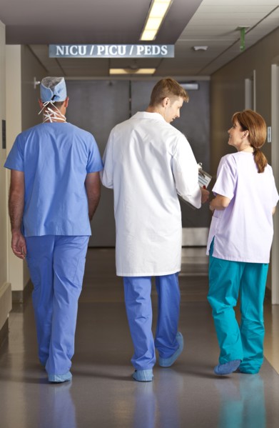 Doctors and surgeons walking in corridor. Photo : db2stock