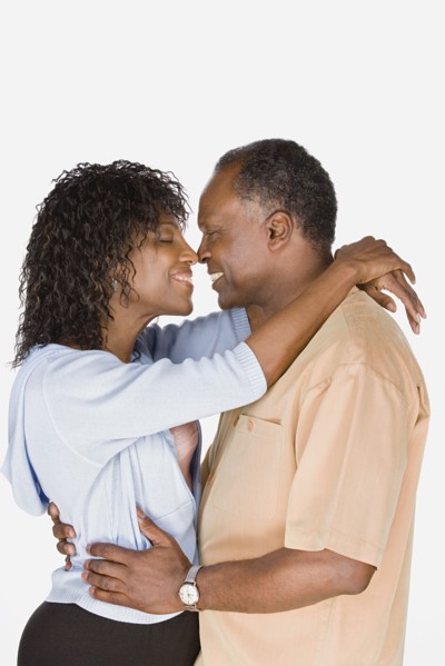 Studio shot of mature couple kissing. Photo : Rob Lewine