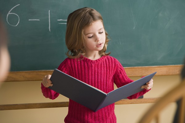 Girl (6-7) having presentation in classroom. Photo: Rob Lewine