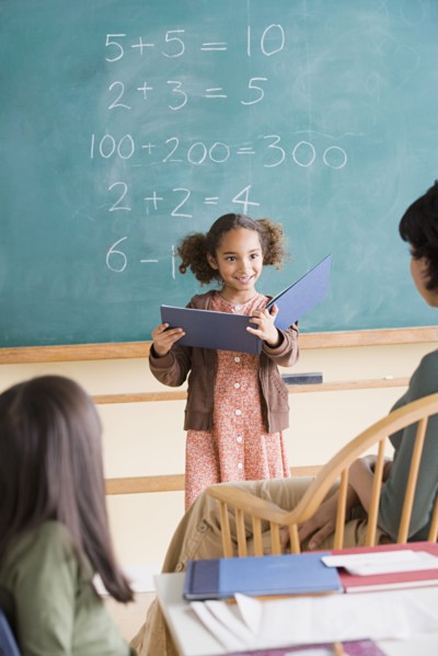 Girl (6-7) having presentation in classroom. Photo: Rob Lewine