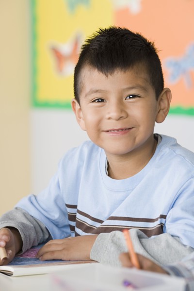 Portrait of boy (6-7) in classroom. Photo : Rob Lewine