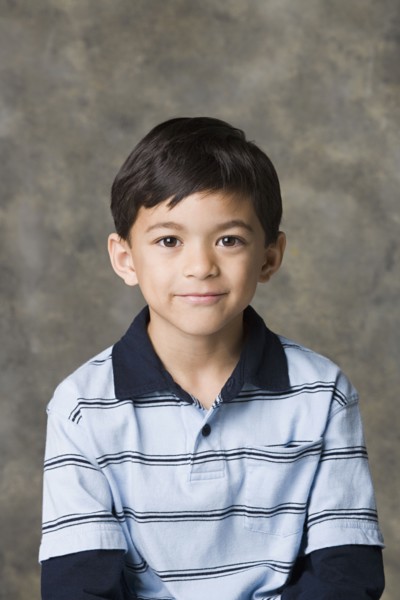 Portrait of smiling boy (8-9), studio shot. Photo : Rob Lewine