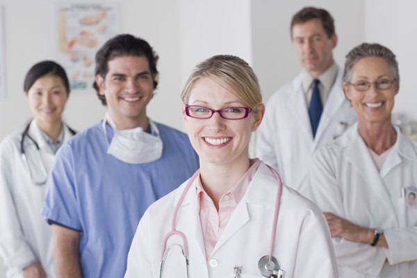 Group portrait of smiling doctors. Photo : Rob Lewine