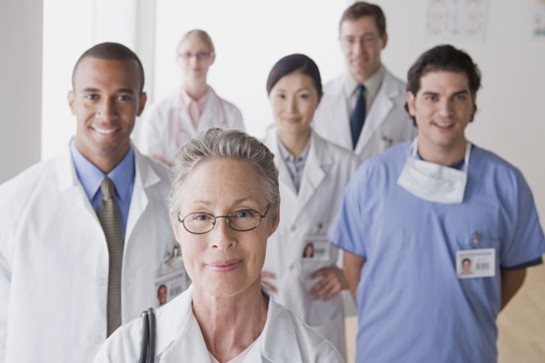 Group portrait of smiling doctors. Photo : Rob Lewine