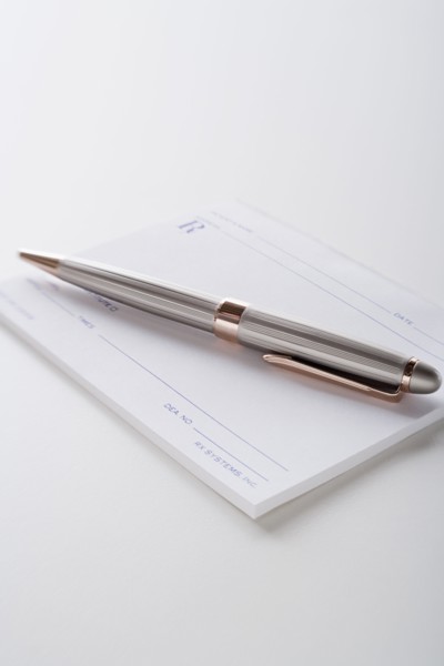 Close up of pen and blank prescriptions, studio shot. Photo : Rob Lewine