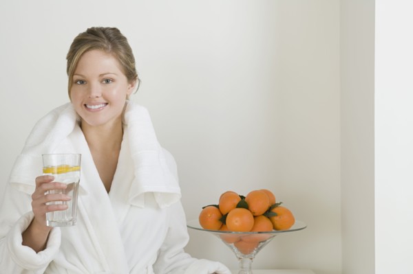 Relaxed woman drinking water. Photo : Rob Lewine