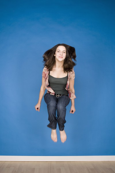 Portrait of teenage girl (16-17) jumping. Photo : Rob Lewine