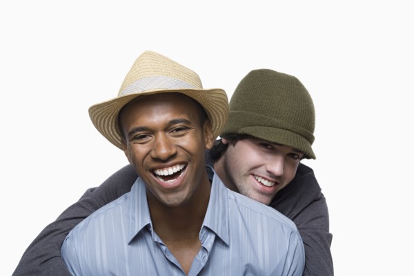 Studio portrait of two young men embracing. Photo : Rob Lewine